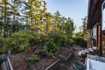 Raised beds at the side of the home may be accessed from the kitchen or front door.