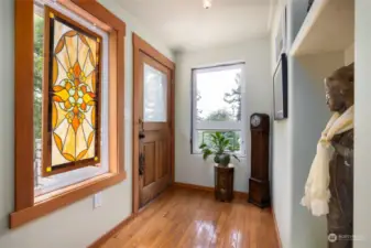 Entry with wood flooring.