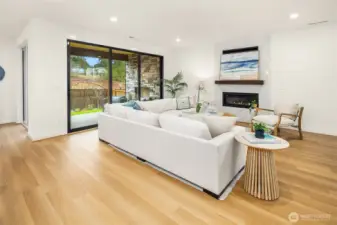 Modern linear gas fireplace with sparkling glass fire stones in great room with full height wall tile is sure to make a statement