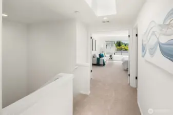 2nd Level Hall w/Skylight. Primary Suite Through French Doors