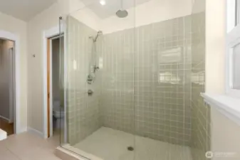 Beautiful, enclosed glass shower in the primary bathroom