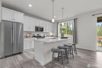 The large island is a focal point of this kitchen. You'll love to host or gather in the inviting kitchen space.