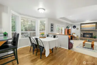 Bay windows overlook the shaded back yard