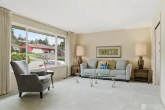 Sun-filled living room with a large east-facing picture window for morning light