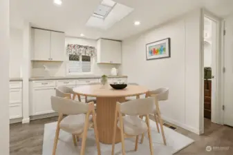 Formal dining room with built in cabinets and counters (match the kitchen), opens to living room.  Virtually staged photo.