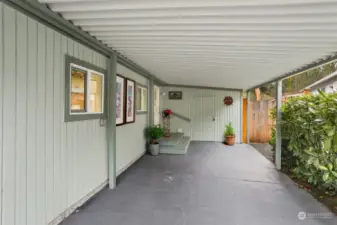 Attached carport has a workshop/shed.