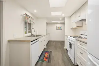 Remodeled kitchen with a gas range, laminate floors, new soft close and slide out cabinets and skylight.