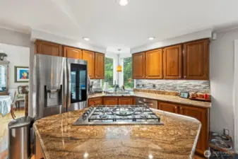 The island 5 burner cook top is a chefs dream with pop up down draft. All appliances are 5 years or newer with exception to the microwave.