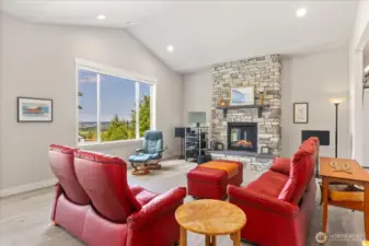 Beautiful floor to ceiling stone gas fireplace.