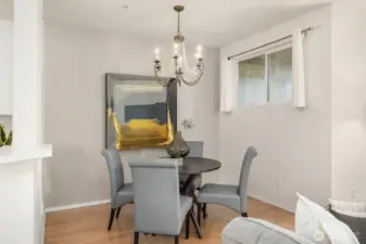 The dining room boasts a stunning chandelier that adds a touch of elegance to the space.