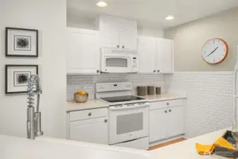 This bright kitchen features an abundance of subway tile, creating a clean and modern look.