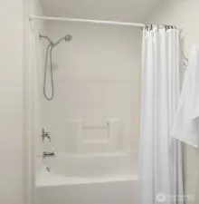 The primary bath boasts a soaking tub, perfect for relaxing after a long day.