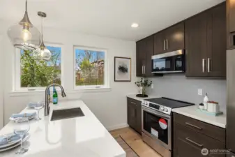 Quartz counters, tiled backsplash and mor.