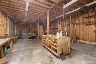 A large garage/shop and outbuilding provide ample workspace.