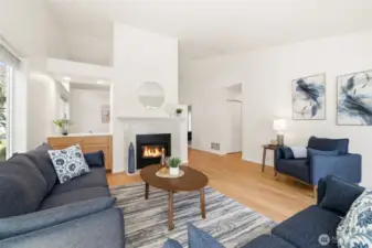 Living room with updated natural gas fireplace with terrazzo tile surround Cocktail bar open to formal dining room.