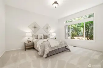 Spacious primary suite with peaceful feel. Large windows bring in natural light.