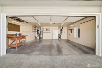 Spacious double car garage with work area.