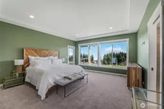 The primary bedroom is a true retreat with incredible views and features deck access, a spacious walk-in closet, and a lovely ensuite.