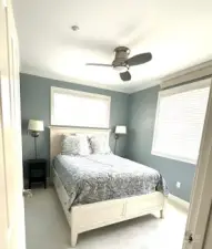 On the opposite end of the condo are the other two bedrooms and ...