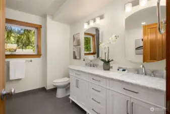 The primary bathroom was recently updated with tiled floors and shower, and clean modern finishes and fixtures.