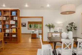 The large, flexible dining space is directly adjacent to the kitchen. Convenient pocket doors can close off this area from the front living room.