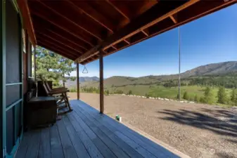 Sit and stay awhile covered porch of Cabin.