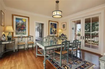 Dining room with French doors that open to expansive decks on both sides.