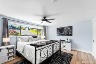 Bright, primary bedroom features on suite bath, walk in closet and, private patio!