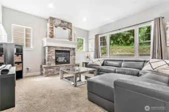 Main living room, note large window and gas fireplace