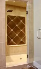 Large walk in shower with bench and two shower heads