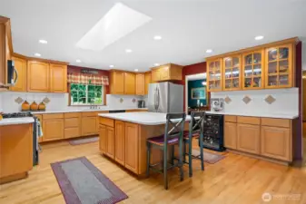 Bright and functional kitchen with skylight, breakfast bar, and tons of storage.