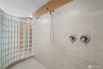 Well-appointed bathroom with large vanity, full tub, and shower