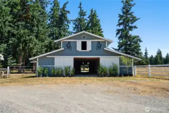 Exceptional equestrian facility featuring 13 total stalls: nine 12x12 stalls and two oversized 14x6 stalls (which can be divided). Each stall includes a dedicated water source. The barn also offers a built-in wash rack, 10 feeding stalls, and spacious hay storage above in the loft.
