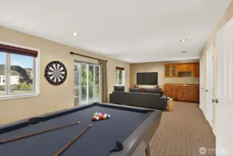 Upstairs rec room with wet bar, spot to add a gas fireplace and an upper deck.