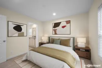 Virtually staged primary bedroom featuring an en suite bathroom and walk-in closet