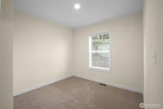 Two additional bedrooms are positioned in the center of the home with a shared bathroom