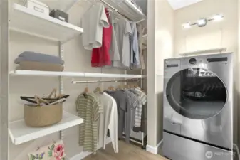 Walk-in closet with new shelving and new washer/dryer.