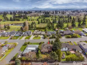 Drone photo to the east over golf course and toward the Cascade Mountain Range.