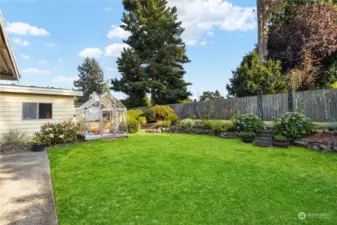 Landscaped yard with flowers in bloom all season and established herb garden.