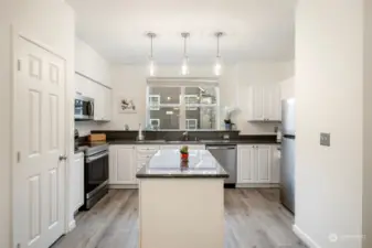 Looking into kitchen dining room space. Pantry on the left.