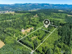 Incredible opportunity to own two adjoining parcels totaling 7.16 acres of serene Pacific Northwest landscape. This aerial view highlights the full scope of the property, including the 2.5-acre homesite and an additional 4.66-acre vacant land parcel—perfect for future development, recreation, or simply preserving privacy and space. Surrounded by trees and forested beauty, this property offers endless potential for hobby farming, trails, gardening, or creating your own rural retreat. Experience peace, quiet, and true country living just beyond the treeline.