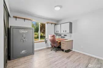 This versatile third bedroom is currently set up as a home workshop and office, complete with built-in metal cabinetry and custom shelving. A large picture window provides inspiring views of the beautifully landscaped front yard. Whether you're working, crafting, or creating, this space is designed to handle it all.