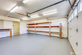 The large 2 car garage- there is tons of built in shelving here, plus a utility room beyond that door with lots more storage.