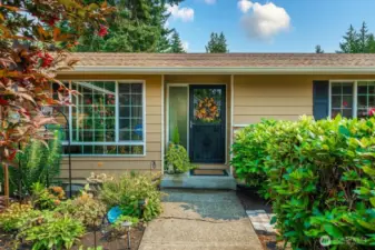 Lush plantings on either side give a welcoming feel as you walk toward the front door!