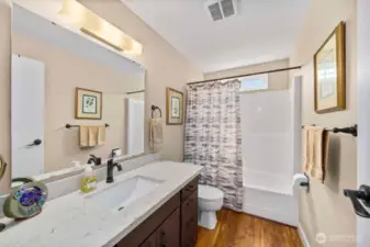Updated hall bath with quartz counters and under mount sink.