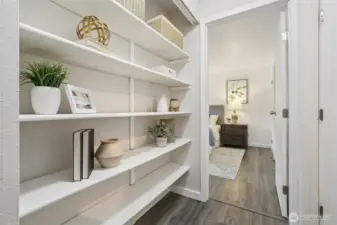 Cute built-in shelving lines the hallway leading to the primary bedroom.