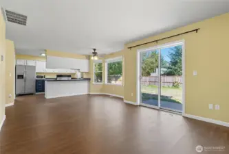 The double glass slider from the Great Room space takes you seamlessly into the huge fenced backyard.