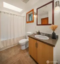 Full bath with tub/shower and laundry in the room. The floor plan is well-considered and compact.