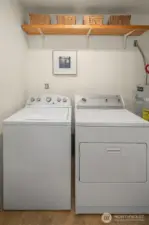 Washer/Dryer in the bath with handy storage shelf.
