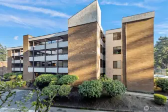 Notice on this fourth-floor end unit, how sightlines from the 2nd bedroom window are   not obstructed by the common walkways. Instead, the window opens to peaceful, long-distance looks at a grove of fir trees and the home's parklike setting.